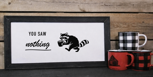 You Saw Nothing raccoon coffee 10 by 20 framed canvas sign in a black wood frame